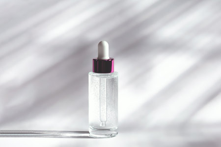 Transparent glass bottle with a dropper and a moisturizing face gel on a white backgroundの写真素材