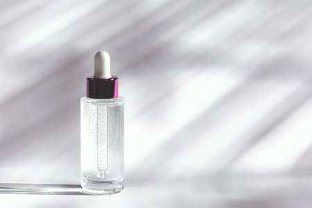 Transparent glass bottle with a dropper and a moisturizing face gel on a white backgroundの写真素材