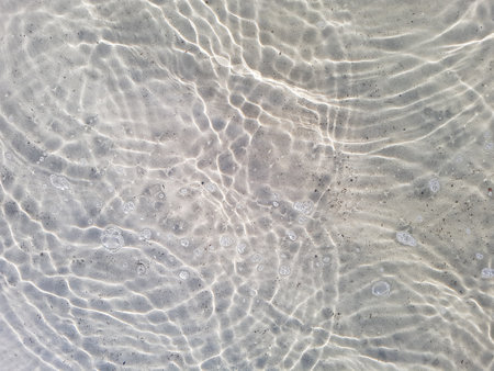 Natural background of water and sand with round streaks on the surfaceの写真素材