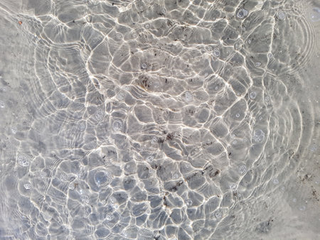 Natural background of water and sand with round streaks on the surfaceの写真素材