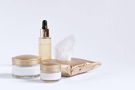 A set for the care of the skin around the eyes and skin consisting of cleaning wipes, glass jars of cream and a bottle with a serum pipetteの写真素材