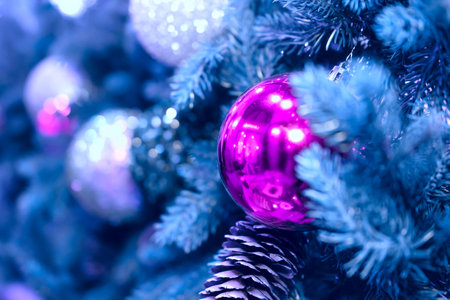 Christmas background with a pink ball that hangs on the tree.の写真素材