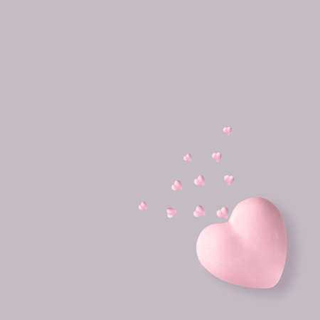 3d illustration. Porcelain pink heart on a gray background from which small hearts fly.の写真素材