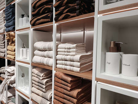 Shelving in the store with neatly folded towels on the shelves and accessories in natural colors.の写真素材