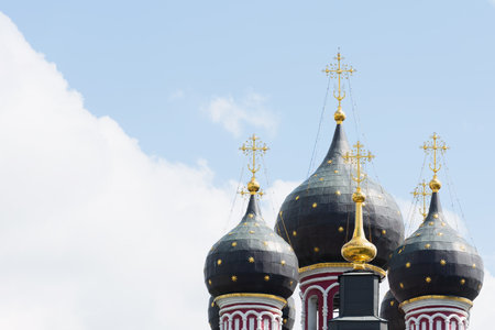 View of the black domes of the Orthodox Church with golden crosses against the skyの写真素材