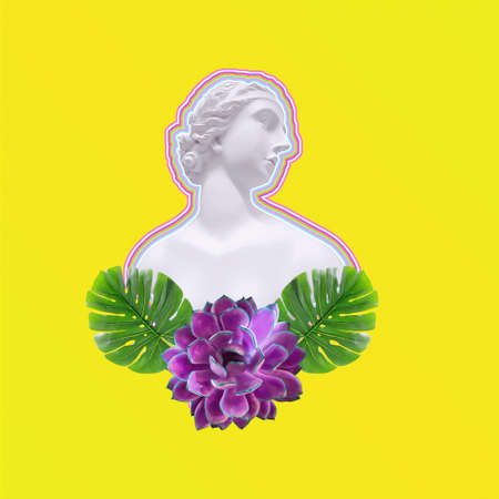 Sculpture of the Greek goddess in palm leaves and flowers on a yellow backgroundの写真素材