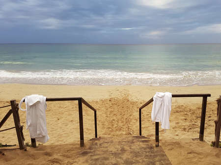 View of the hotels sandy beach, sea and gloomy sky.の写真素材