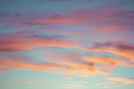 Bright colorful sky at sunset in orange pink purple and blue colors.の写真素材