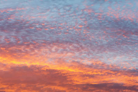 Bright colorful sky at sunset in orange pink purple and blue colors.の写真素材