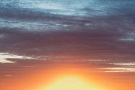 Bright colorful sky at sunset in orange pink and purple colors.の写真素材