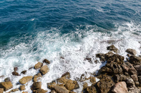 Waves on sand and rocks  near beachの写真素材
