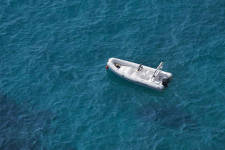 Aerial view of a white speed boat on a blue clear sea waterの写真素材