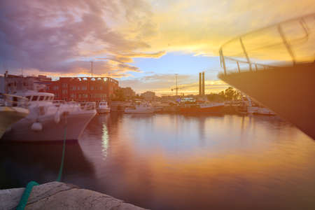 Fishing boats in Monipoli bay with sunset sky background, southern Italyの写真素材