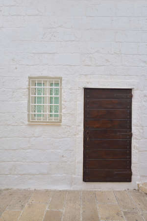 Traditional facade of south adriatic sea house with door and window minimalist decorated in small village of Monopoli, south Italyの写真素材