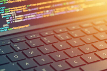 Closeup coding on screen, hands coding html and programming on screen laptop, web development, developerの写真素材