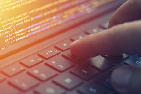 Closeup coding on screen, hands coding html and programming on screen laptop, web development,...