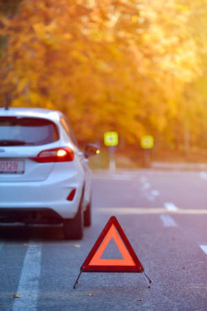 Broken car concept, breakdown triangle on roadの写真素材