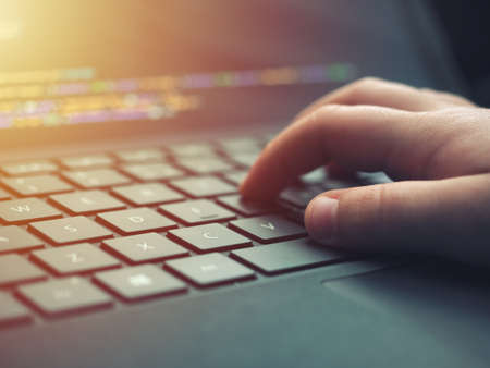 Closeup programmer coding on screen. Hands coding html and programming on laptop screen, web...