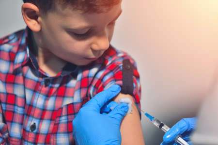Close-up hands doctor or nurses are vaccination to patient using the syringe injected upper arm for treated. Doctor giving an injection to a patientの写真素材