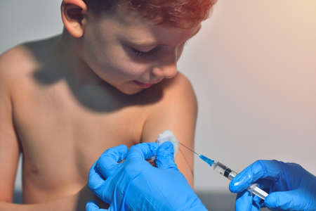 Close-up hands doctor or nurses are vaccination to patient using the syringe injected upper arm for treated. Doctor giving an injection to a patientの写真素材
