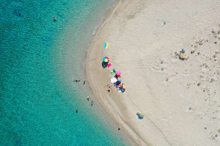 Aerial drone view of iconic small uninhabited island of Marathonisi featuring clear water, sandy shore and natural hatchery of Caretta-Caretta sea turtles, Zakynthos, Greeceの写真素材