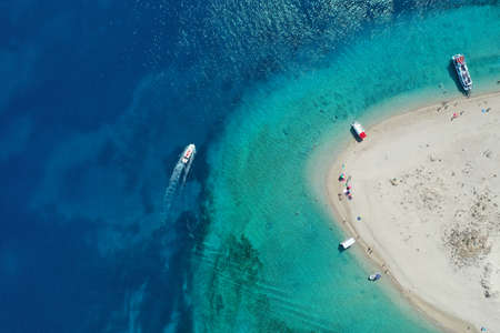 Aerial drone view of iconic small uninhabited island of Marathonisi featuring clear water, sandy shore and natural hatchery of Caretta-Caretta sea turtles, Zakynthos, Greeceの写真素材