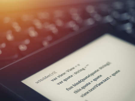 High view of a ebook reader with programing lessons on a laptop keyboard in a coding schoolの写真素材