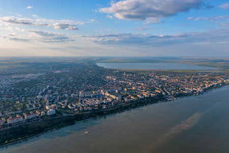 Aerial view of Galati City, Romania. Danube River near city with sunset warm lightの写真素材