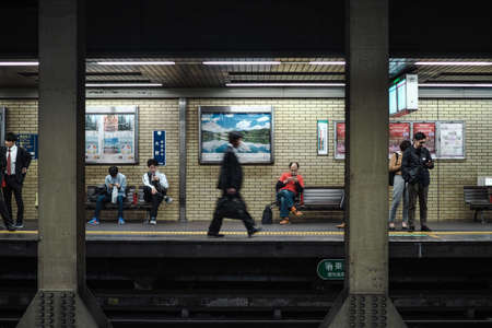 Japaneses waiting for a train in the morning at Omiya station, Kyoto. shot on 22 october 2018.のeditorial素材