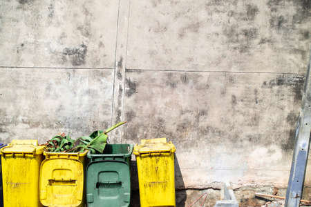 Streetside colorful waste bins withâ€‹ banana leavesâ€‹ putâ€‹ besideâ€‹ old...