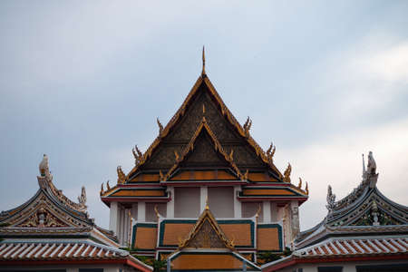 Front view of Thai Buddhism temple's roof with glimpse of chinese pavilion's roof at Wat Kalayanamitr, Bangkok.の写真素材
