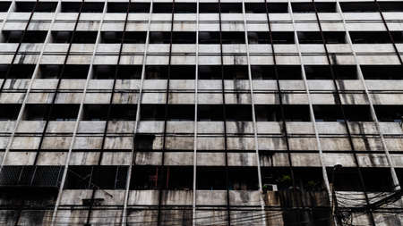Low angle view of multi-floor building with faded color and dark corridor.の写真素材