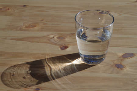 A glass with water  on a wooden table