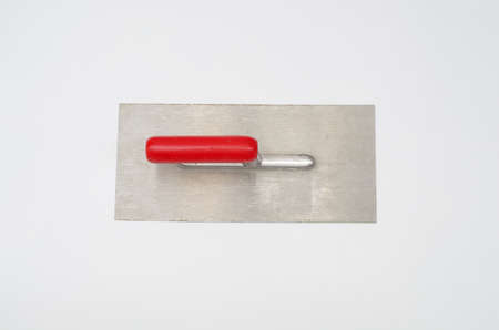 metal plastering trowel with red handle
