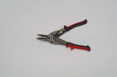 metal shears with red handles isolated view, white background