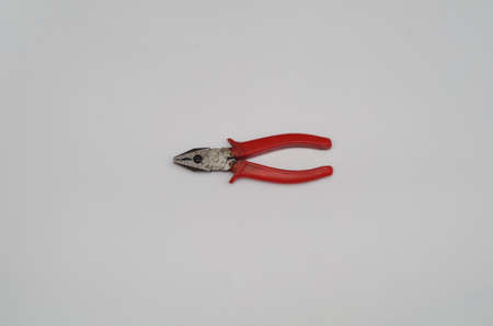 isolated view of small pliers with high-voltage electrical insulation with red handlesの写真素材