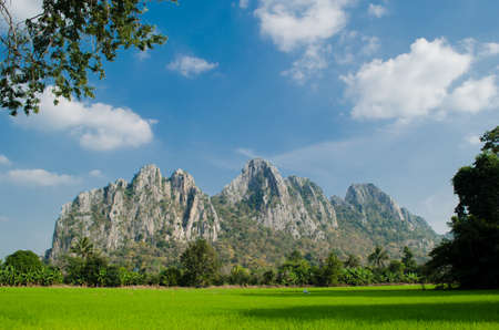 Kao Nor Kao Kawg is limestone mountain in Nakon sawan Province and have green paddy ,blue skyの写真素材