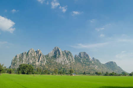 Kao Nor Kao Kawg is limestone mountain in Nakon sawan Province and have green paddy ,blue skyの写真素材