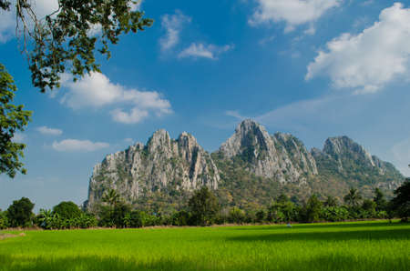 Kao Nor Kao Kawg is limestone mountain in Nakon sawan Province and have green paddy ,blue skyの写真素材