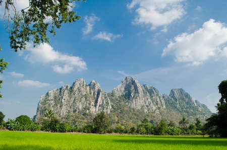 Kao Nor Kao Kawg is limestone mountain in Nakon sawan Province and have green paddy ,blue skyの写真素材