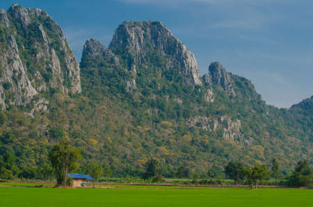 Kao Nor Kao Kawg is limestone mountain in Nakon sawan Province and have green paddy ,blue skyの写真素材