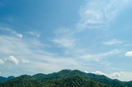 top view of forest in thailand and blue sky. some  areas is change ground to agricultureの写真素材