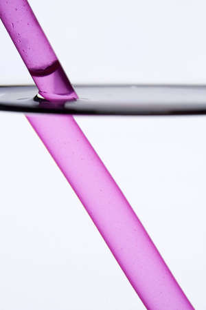 Drinking straw refracted by waterの写真素材