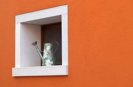 Small window with watering can