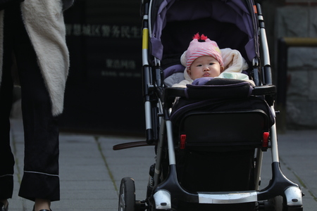 Chinese baby in pram taken in February 2017 in Shanghai, Chinaのeditorial素材