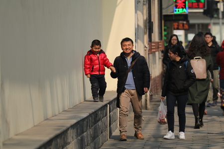 Happy Chinese family, man holding son's hand, wife looking at family, taken in Shanghai, China in February 2017のeditorial素材