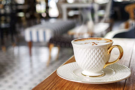 Cup of hot coffee cappucino on wood table in coffee shop background, soft focusの写真素材