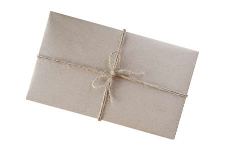 Gift box wrapped in brown recycled paper and tied with rustic burlap twine top view isolated on...