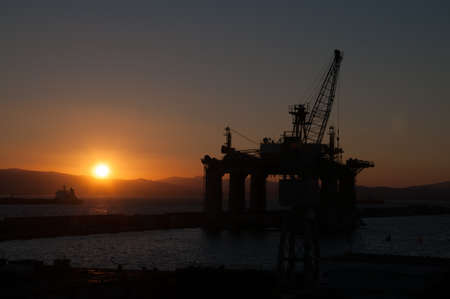 Sunset in Gibraltar showing a prospection platform over the sea