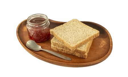 whole wheat bread and strawberry jam on a white backgroundの写真素材